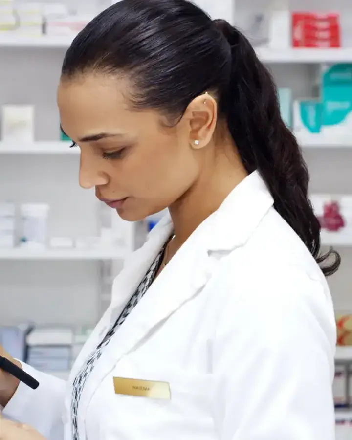 woman in pharmacy looking at a bottle
