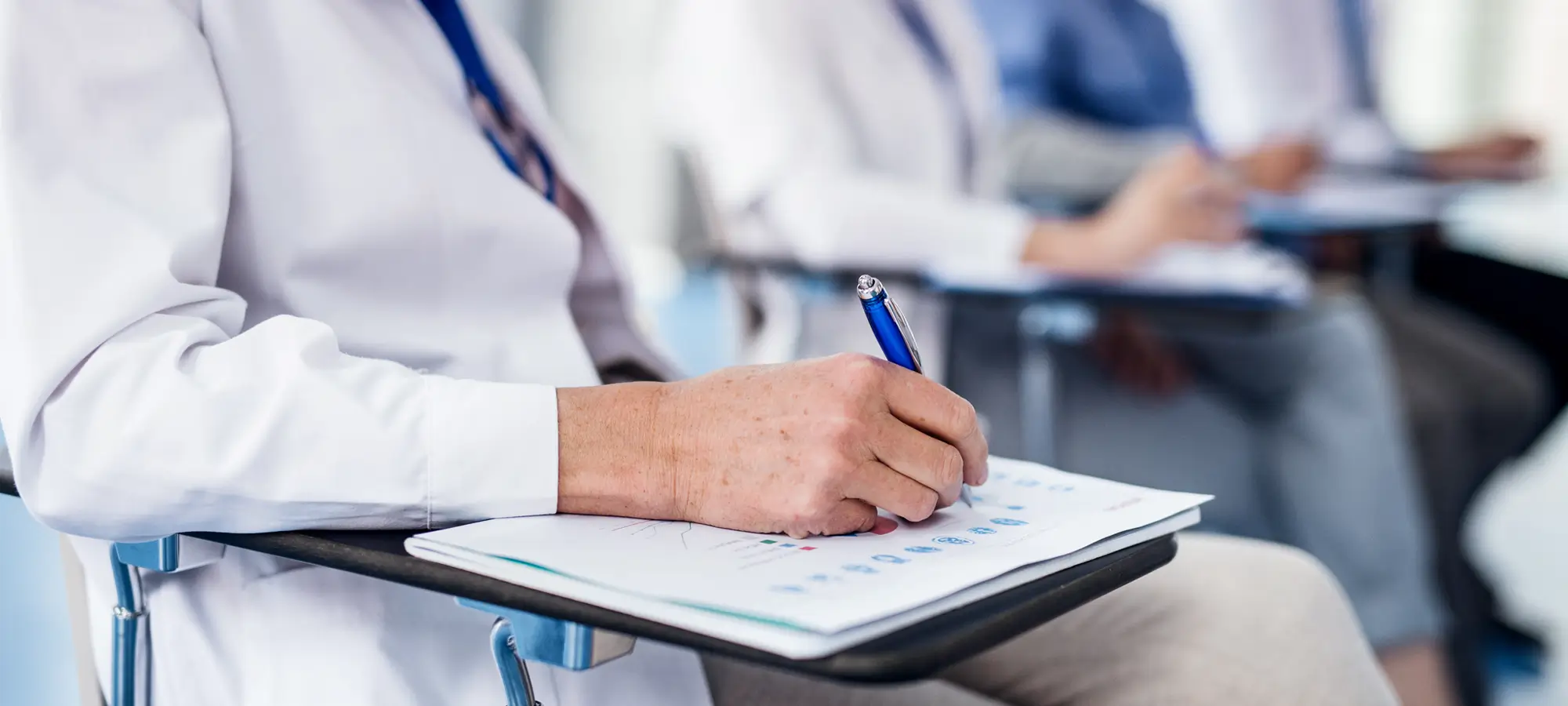 a doctor writing on a clipboard