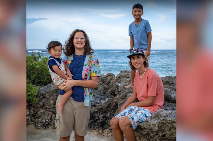a-group-of-young-men-one-holding-a-child