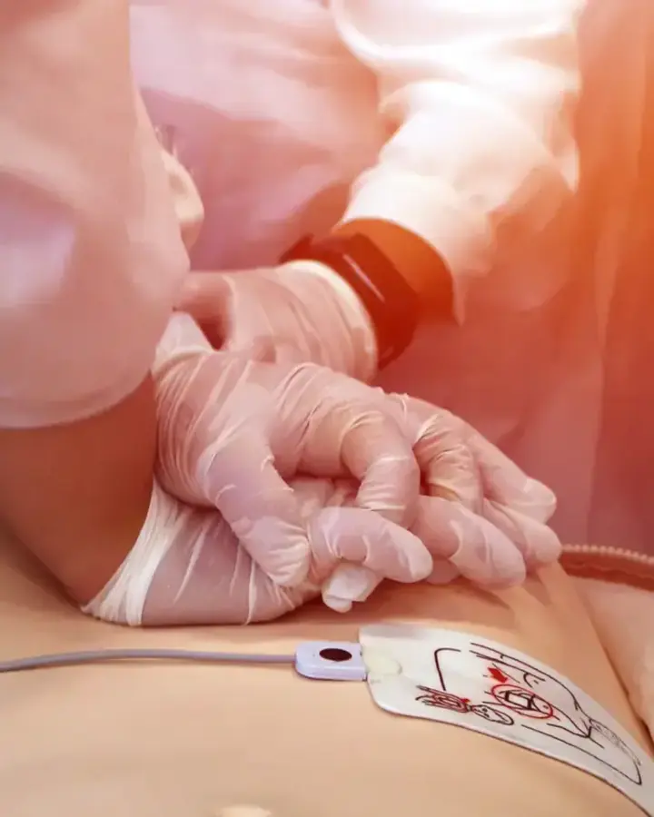 doctor doing chest compression on a sim