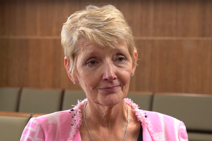 woman-smiling-with-chairs-in-the-background